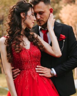 A woman in red with her man in a suit and they are sttaring in each other's eyes. Soul Mate Activation Package 1 - 45 Minute Zoom Session, Angus Mac Og Reiki Attunement followed up with a 200-250 word follow up email reading + manifesting techniques and dream activation.