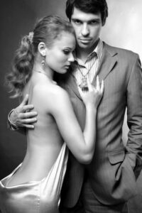 Portrait of a young beautiful couple. Young woman embraces man.