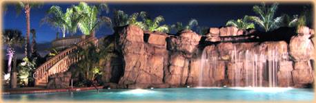 Caliente Clothing Optional Resort At Night Featuring the big lagoon pool