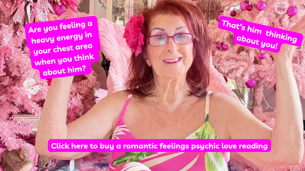 Linda Kaye, Pink Chick Psychic, is sitting in front of her pink tree with a pink and green dress on letting you know that if you feel an intense energy in your chest area when you think about your lover, he is thinking about you too.